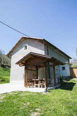 a small building with a table in front of it at Amber STUDIO in Kobarid
