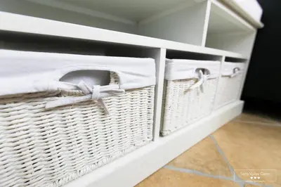 a laundry room with wicker baskets on a shelf at Amber STUDIO in Kobarid