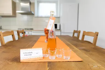 a bottle of wine sitting on a table with glasses at Amber STUDIO in Kobarid