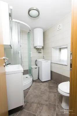 a bathroom with a sink and a toilet and a mirror at Amber STUDIO in Kobarid