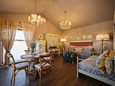 a bedroom with a bed and a table and chairs at HOTEL StDaniel in Štanjel