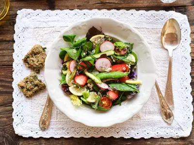a salad in a white plate on a table at HOTEL StDaniel in Štanjel