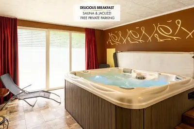 a hot tub in a room with graffiti on the wall at Guest House Hober in Prevalje