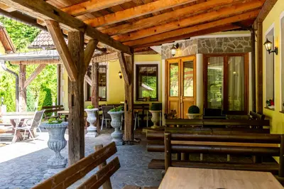 a church with benches and tables and chairs at Guest House Hober in Prevalje