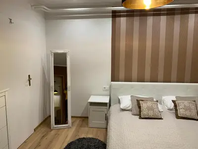a bedroom with a bed and a mirror at Apartma Eli in Bled