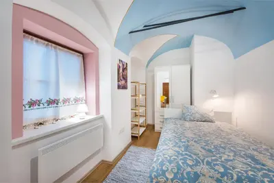 a bedroom with a bed and a window at Codelli Deluxe City Centre Apartments in Ljubljana