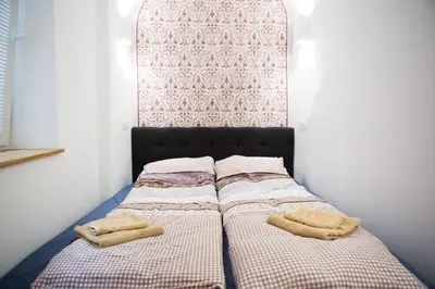 two beds sitting next to each other in a bedroom at Codelli Deluxe City Centre Apartments in Ljubljana