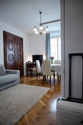 a living room with a table and a dining room at Codelli Deluxe City Centre Apartments in Ljubljana