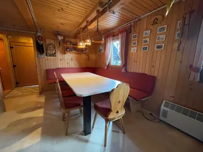 a dining room with a table and chairs at Velika Planina Koča Kekec in Stahovica