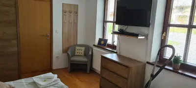 a bedroom with a bed and a tv and a chair at Gorenjka in Kranjska Gora