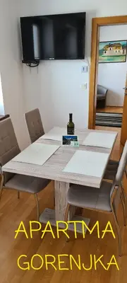 a table with a bottle of wine sitting on top of it at Gorenjka in Kranjska Gora