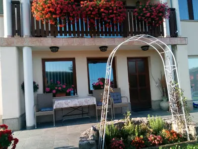 a balcony of a building with flowers on it at Dolenjska vila with Private Sauna in Žužemberk