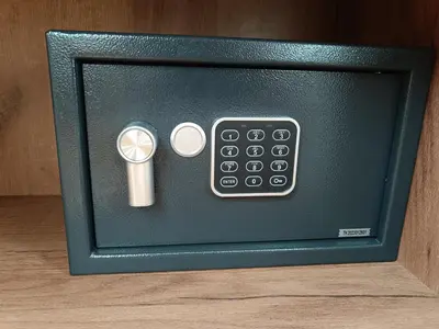 a microwave with a remote control in a box at Dolenjska vila with Private Sauna in Žužemberk