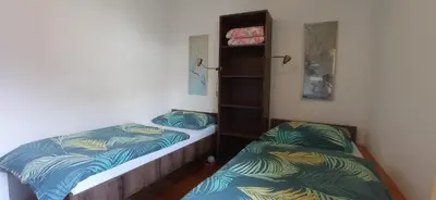 two beds in a small room at Apartments Kapus Center in Bled