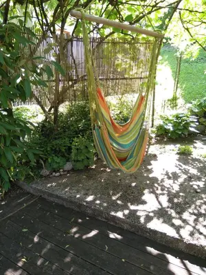 a colorful hammock hanging from a tree at Apartments Kapus Center in Bled