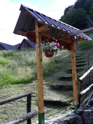 a solar roofed pergola with a flower pot at Holiday Home Na planini in Tolmin