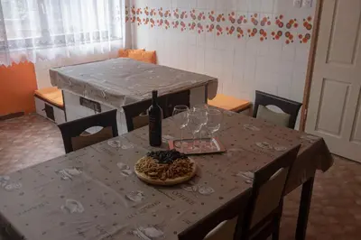 a table with a bottle of wine and a plate of food at Apartment Gaja in Tolmin
