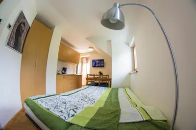a small bedroom with a bed with a lamp in it at A Million Dollar View in Kranjska Gora