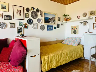 a room with a bed and plates on the wall at House for nature lovers in Medvode