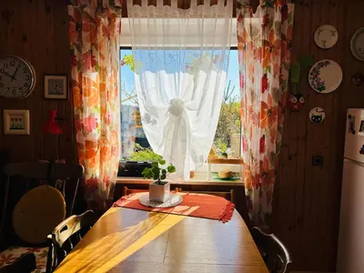 a table in a kitchen with a window at House for nature lovers in Medvode