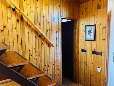 a wooden wall with a staircase in a room at House for nature lovers in Medvode