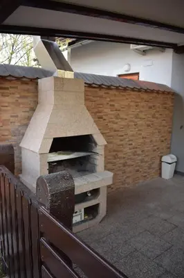a stone pizza oven on a patio at Borovnica Čatež in Čatež ob Savi