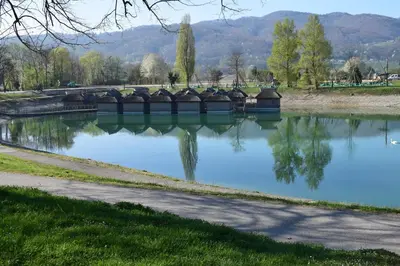 a pond with a bridge in a park at Borovnica Čatež in Čatež ob Savi