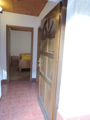 a door leading into a room with a bedroom at Apartma Lesjak 1 in Bovec