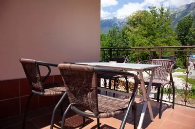 a table and chairs on a balcony with a view at Apartma Lesjak 1 in Bovec