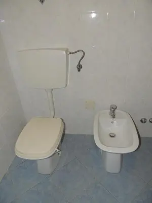 a bathroom with a toilet and a sink at Lesjakova Domačija in Bovec