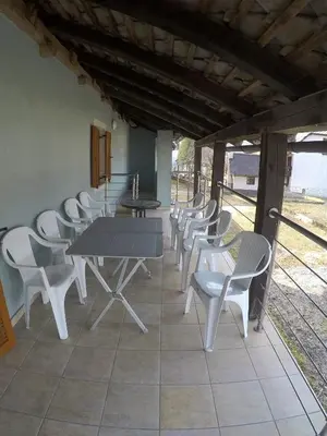 a group of tables and chairs on a patio at Lesjakova Domačija in Bovec