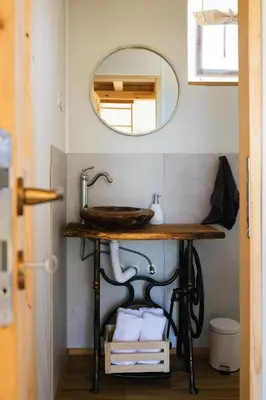 a bathroom with a sink and a mirror at Glamping Kolpa Resort in Gradac