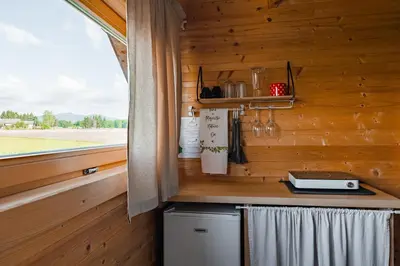 a kitchen with a counter and a window in a cabin at Glamping Kolpa Resort in Gradac