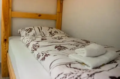 a bunk bed with two towels on top of it at Apartma Kamp Ajdovščina in Ajdovščina