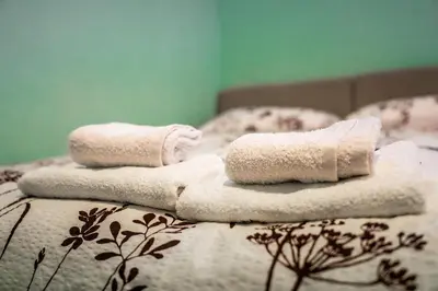 two towels sitting on top of a bed at Apartma Kamp Ajdovščina in Ajdovščina