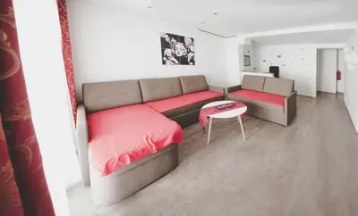 a living room with a couch and a table at Apartma Trebušca in Dolenja Trebuša