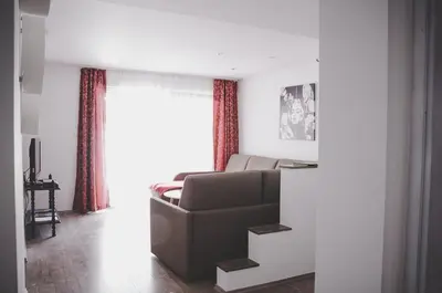 a living room with a couch and a window at Apartma Trebušca in Dolenja Trebuša