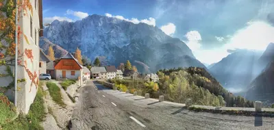 a village in the mountains with a mountain at Predel House in Log pod Mangartom
