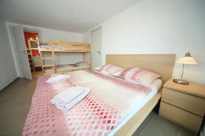 a bedroom with a large bed with two towels on it at Apartments Planica in Kranjska Gora