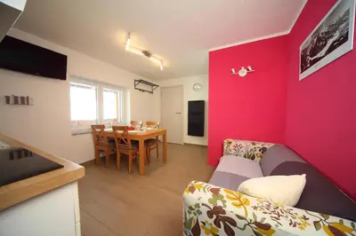 a living room with a couch and a table at Apartments Planica in Kranjska Gora