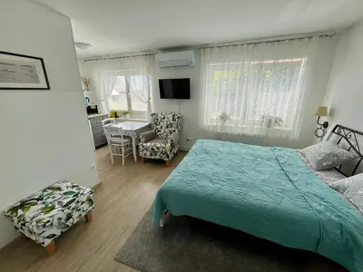 a bedroom with a bed and a table and chairs at Villa Mint&Lavender ID1O1674 in Bled