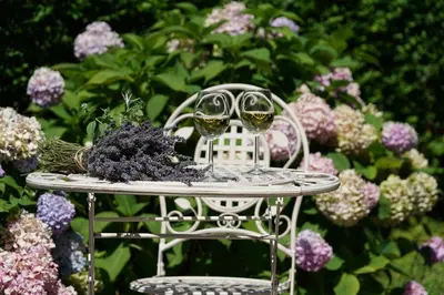 two glasses of wine sitting on a table in front of flowers at Villa Mint&Lavender ID1O1674 in Bled