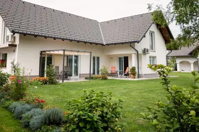 a house with a garden and a lawn at Sobe Meta in Brezje