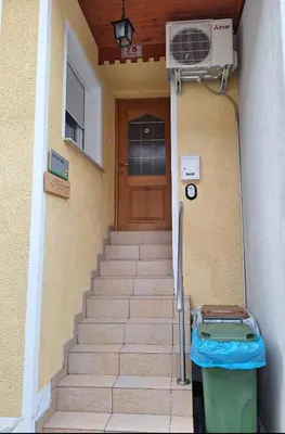 a stairs leading to a door with a fan next to it at Apartma Pr Maruši in Bovec