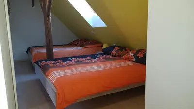 two beds in a room with a attic at Apartma Pr Maruši in Bovec