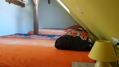 a bedroom with a bed with an orange bedspread at Apartma Pr Maruši in Bovec