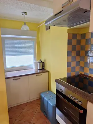 a kitchen with a stove and a window at Apartma Pr Maruši in Bovec