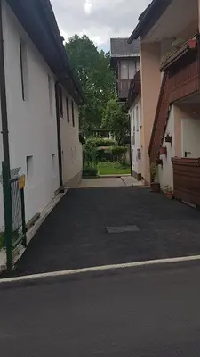 an empty parking lot between two buildings at Apartma Pr Maruši in Bovec