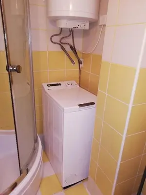 a small bathroom with a toilet and a washer at Apartma Pr Maruši in Bovec