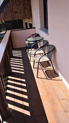 a patio with two chairs and a table on a balcony at Holiday Home Julian Alps in Bovec